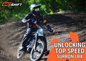 Surron Top Speed Banner featuring a rider on a surron on a berm