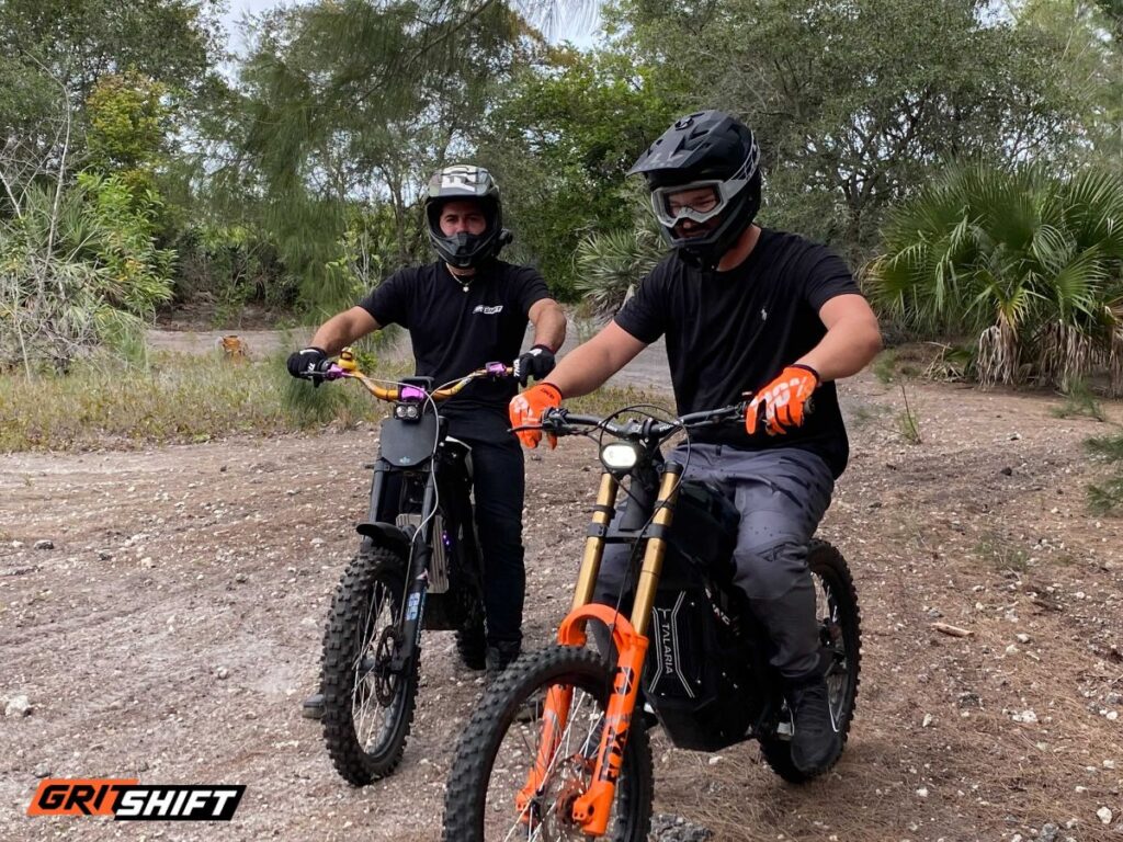 riders on a Talaria e-moto on a track 