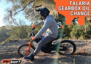 a rider on an electric dirt bike on a track